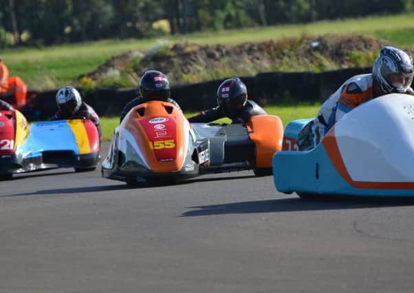 The husband-and-wife sidecar-racing team, Giles and Jen Stainton, in action at Cadwell Park. (PHOTO BY: Sid Diggins)