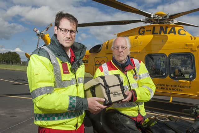 Dr David Cookson accepts a blood delivery from one of the Blood Bikers.