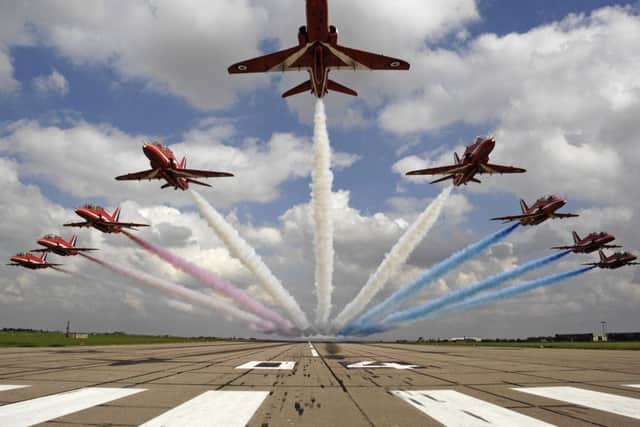 The Red Arrows performing a low-level flypast at RAF Scampton.