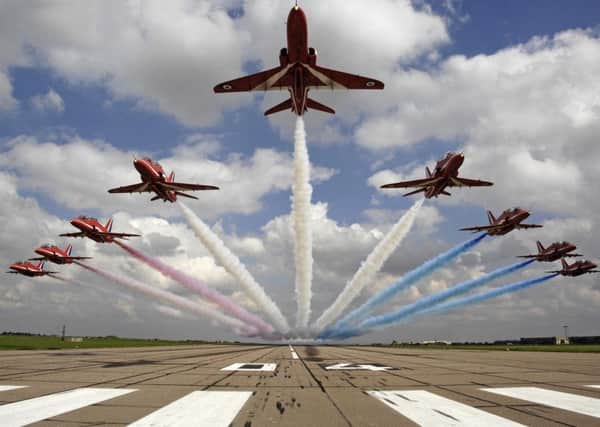 The Red Arrows performing a low-level flypast at RAF Scampton.
