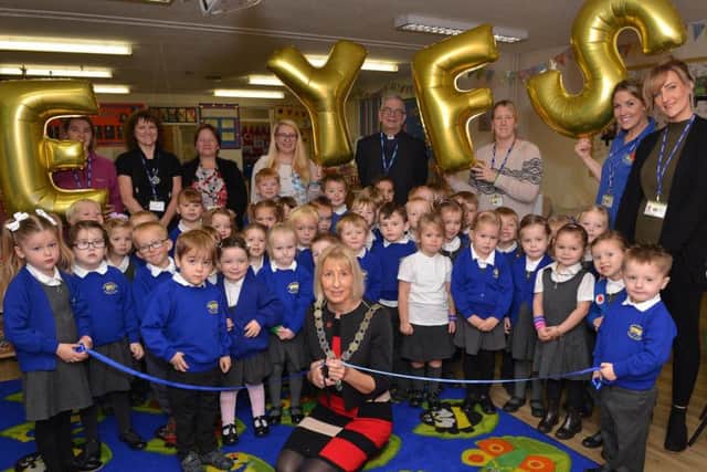 Gainsborough Mayor Coun Sally Loates cuts the ribbon, pictured with children, staff and the Rev Canon Michael Cooney. Photos by Rachel Atkins.