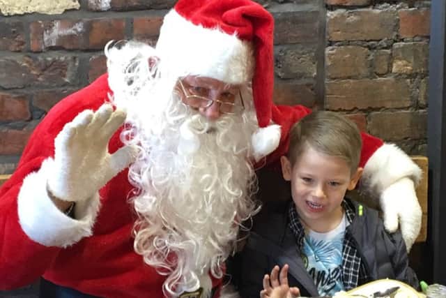 Father Christmas at Root and with five year old Riley Vernon - one of the competition winners.