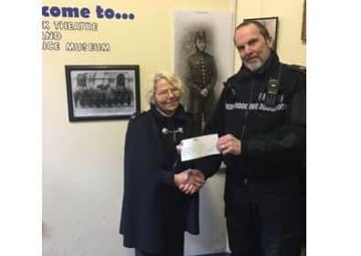 PC Ian Shaw presents a cheque for £450 to Eleanor Bowker.