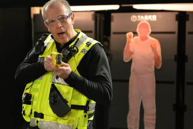 Lincolnshire Police have a new model of taser in use which is safer, faster and more effective, pictured is PC Chris Davies demonstrating the new taser
