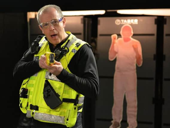 Lincolnshire Police have a new model of taser in use which is safer, faster and more effective, pictured is PC Chris Davies demonstrating the new taser