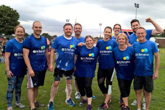 St Barnabas Hospice duo, Chris Wheway (fourth from left) and Caroline Swindin (third from right), taking part in an Its A Knockout event, based on the former TV show.
