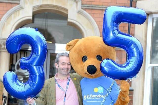 Chris with a mascot celebrating the hospices 35th birthday.