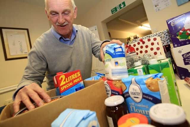 Alan Diggles, CEO of HOPE, sorts through a food parcel.