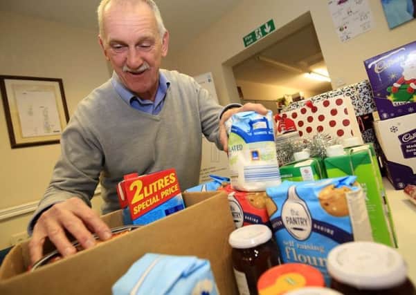 Alan Diggles, CEO of HOPE, sorts through a food parcel.