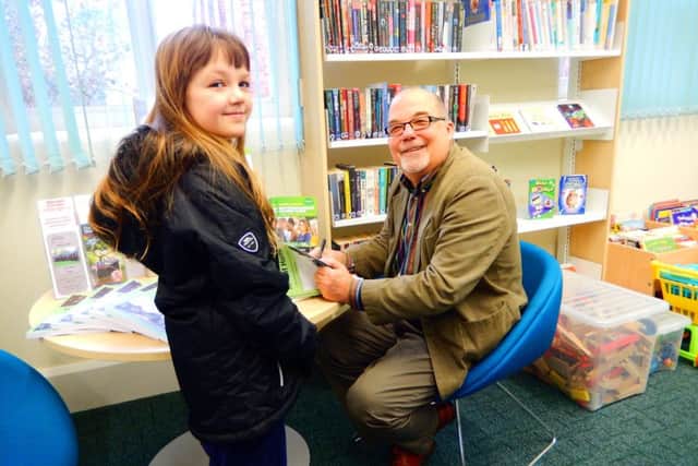 The very first customer, 10-year-old Chloe Mapleback from Misterton with David Seymour