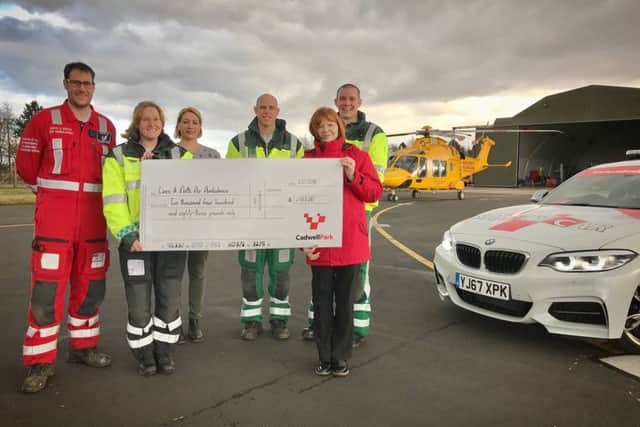 Cadwell Park Events Co-ordinator, Elaine Nutbrown presents a cheque to Lincolnshire Air Ambulance Trust