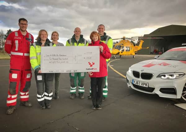 Cadwell Park Events Co-ordinator, Elaine Nutbrown presents a cheque to Lincolnshire Air Ambulance Trust