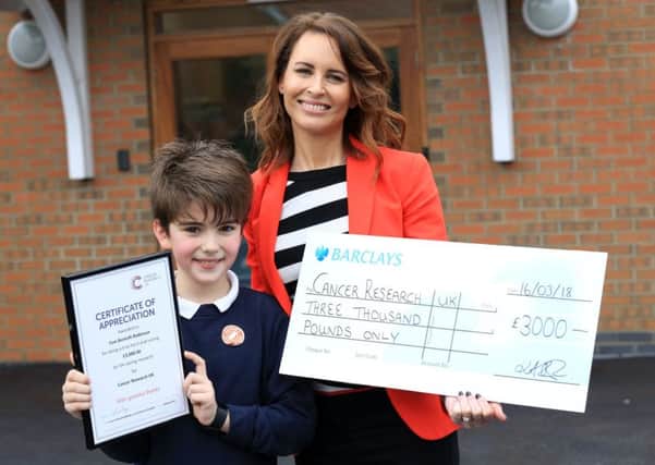 Tom Bontoft-Robinson from Corringham Primary has raised Â£3000 for Cancer Research UK. Tom is pictured with Sarah Mullen, fundraiser from Cancer Research.