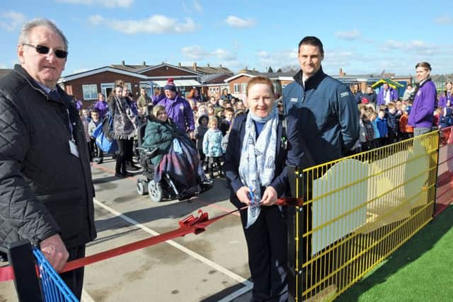 Gainsborough Tesco's Christine Fraser and Daniel Norburn, prepare to cut the ribbon with chairman of Governors, Bill Grant and staff and pupils at the Hillcrest Early Years Academy, to officially open their new all weather sports pitch.