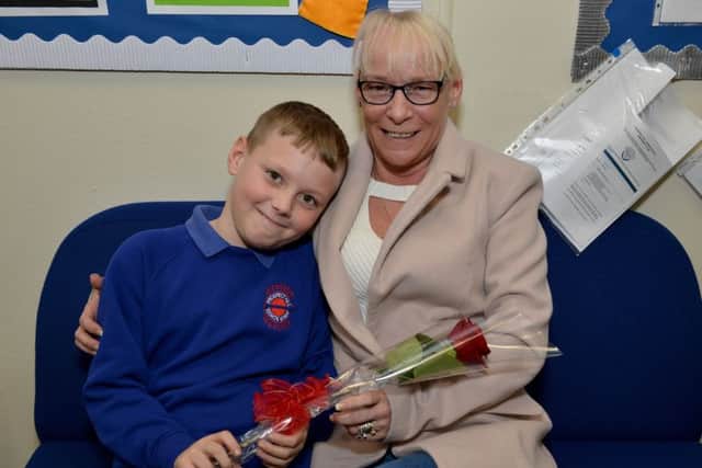 Lucas Fisher, nine presents his Nan Tricia Eccleston with the Guardian Rose at Prospect Hill Junior School