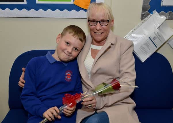 Lucas Fisher, nine presents his Nan Tricia Eccleston with the Guardian Rose at Prospect Hill Junior School