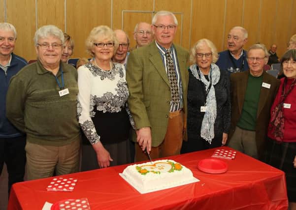Cardiac Support Group 25th anniversary, current chair Chris Coldwell and founding chair Peter Snell cut the celebration cake watched by members