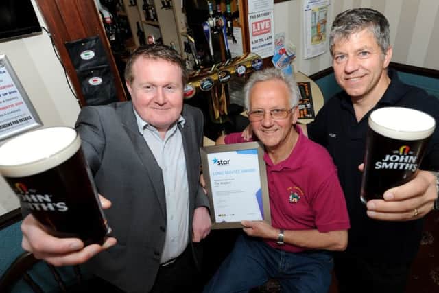 Saxilby licensee Mike Brown with his son Wayne and Paul Willis, of Star Pubs & Bars, who presented the long service award.