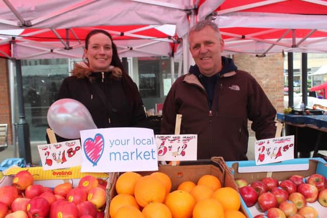 Veteran trader Flynn Harding (right) and a colleague on the Flynns Fruits stall that he owns.