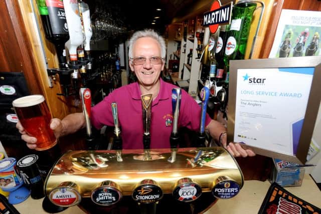 Saxilby licensee Mike Brown receives a long service award for his quarter of a century at the pub.