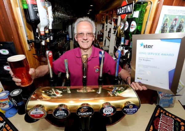 Saxilby licensee Mike Brown receives a long service award for his quarter of a century at the pub.
