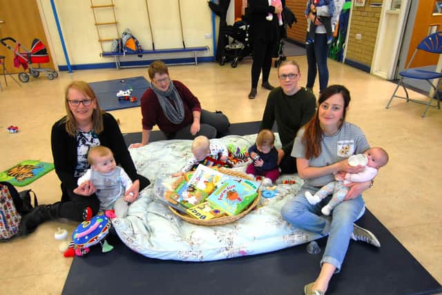 Families Enjoying Everything Together (FEET) at Brown's School, Horbling, a free parent and toddler group for ages 0-5. Parents enjoying a book themed play session.