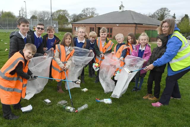 Stick up for your environment event at Leadenham village hall. Leadenham Primary School's Woodpeckers class pupils and members of the School Council, litter picking with Lisa Ashcroft.