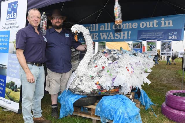 Heckington Show. L-R Julian Boden of Welland and Deeping Internal Drainage Board and Andy Scott of Black Sluice IDB with a swan made with plastics by Reception and Year 1 Cranwell Primary School pupils.