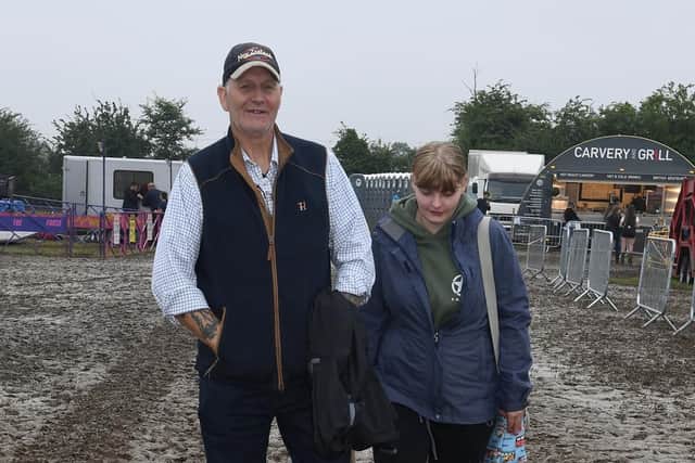 Heckington Show. Steve Markahm with his daughter Kelly Markham walking through the mud.