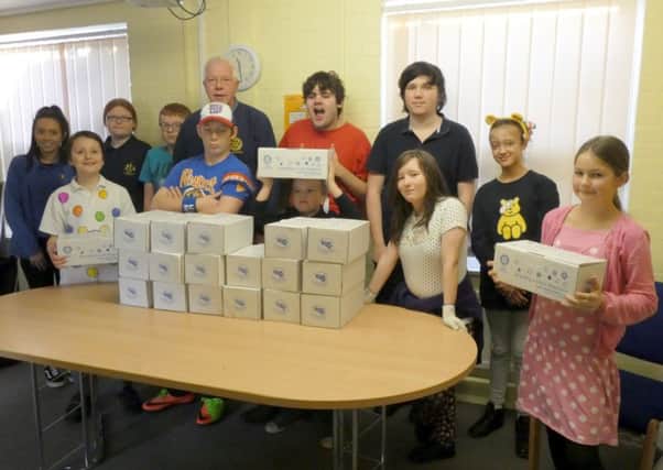 Students at St Lawrence School supported the Rotary Shoebox appeal with 20 filled boxes and bags of toys and gifts. Rotarian Peter Humphrey is pictured with some of the students when he went to collect the boxes. EMN-171128-113342001