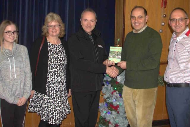 Heckington film maker Steve Parry, accompanied by wife Julie and daughter Sophie, presents show chairman Charles Pinchbeck and film presenter Andrew Key with a copy of the completed film. EMN-170512-105912001