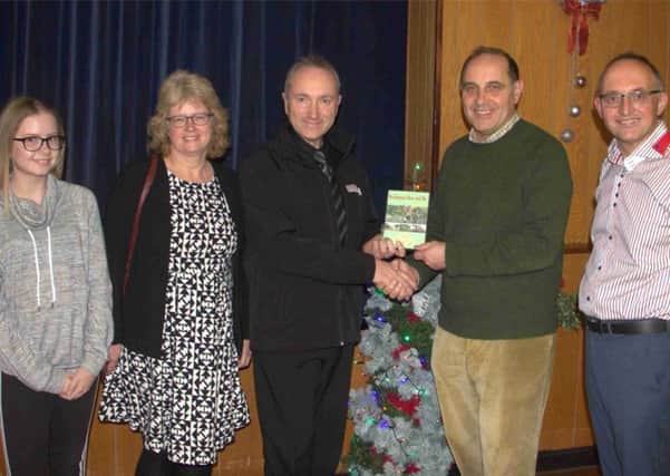 Heckington film maker Steve Parry, accompanied by wife Julie and daughter Sophie, presents show chairman Charles Pinchbeck and film presenter Andrew Key with a copy of the completed film. EMN-170512-105912001