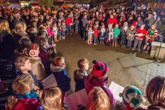 St Andrews, St Hughs and Kirkby On Bain Primary School choirs singing to the crowds at last year's Woodhall Spa Chrisrmas Market. EMN-171129-095514001