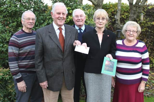 Heather hands over the cheque to Graham Rodwell with members of the DOCATEF committee.