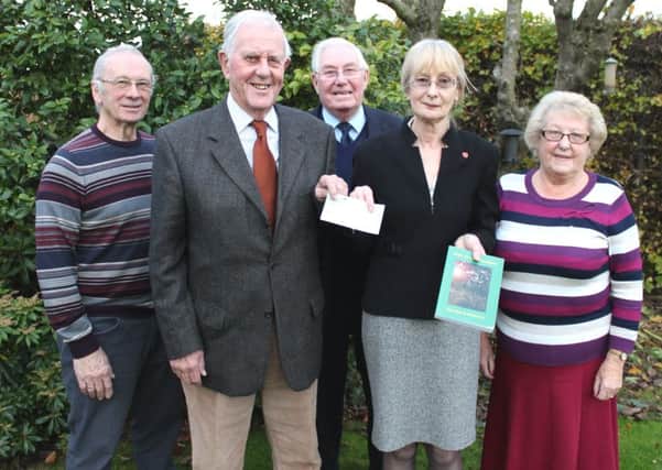 Heather hands over the cheque to Graham Rodwell  with members of the DOCATEF committee.