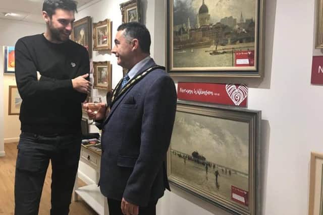 Artist Ed Waite reminisces with Mayor of Skegness Coun Danny Brookes about the days he spent near the RNLI station when he was growing up. where the Mayor has an ice-cream kiosk.by ANL-170112-155239001
