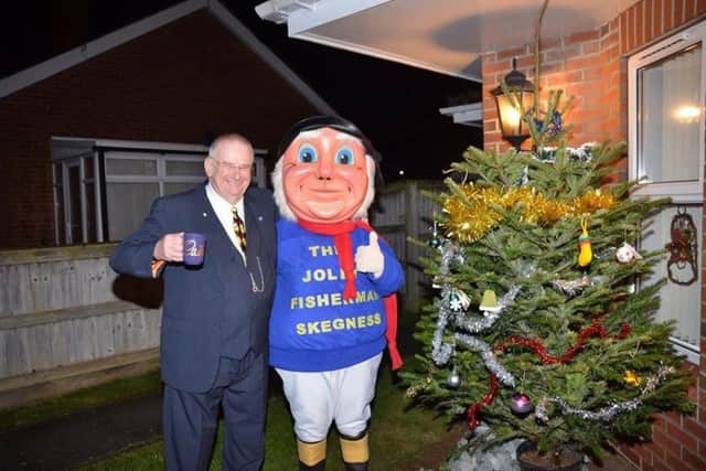Coun David Cargill and the Jolly Fisherman at the Philip Grove Memory Tree in Skegness. Photo: Barry Robinson. ANL-170412-125639001