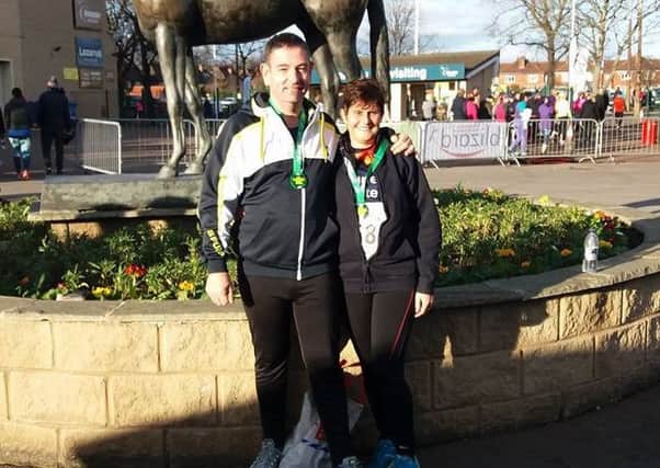 Nathan Fisher and Rachel Shinn wearing their medals after the Doncaster 10k.