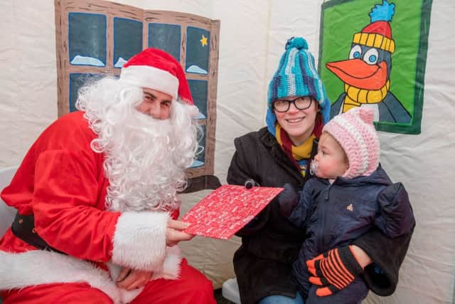 It might have been  cold and wet but nothing was going to stopTalia Beck (18 months) and mum Lynzi Beck from visiting Santa Claus, who proved to be as popular as ever at the towns Christmas Market. EMN-171012-191142001