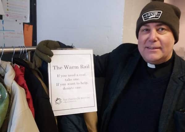 The Rev Steve Holt with the warm rail of donated winter coats at St Christophers Church, Boston.
