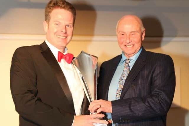 Andy Molsom collects his second place trophy from Geoff Lees.