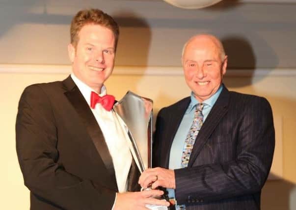Andy Molsom collects his second place trophy from Geoff Lees.