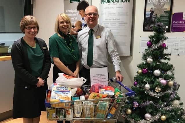 Dawn Wells, Clare Wilkinson  and Andrew Twelvetrees of Lloyd's Bank with the trolley of food donated to Horncastle Community Larder EMN-171112-083033001