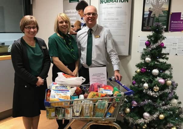 Dawn Wells, Clare Wilkinson  and Andrew Twelvetrees of Lloyd's Bank with the trolley of food donated to Horncastle Community Larder EMN-171112-083033001
