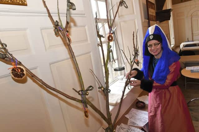 Medieval Christmas with Knights of Skirbeck, at Guildhall. Caroline Bedford decorating a medieval christmas tree. EMN-171112-112706001