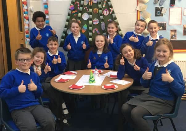 Double thumbs up ... pupils at St Botolph's during a Great British Tea Party last week.