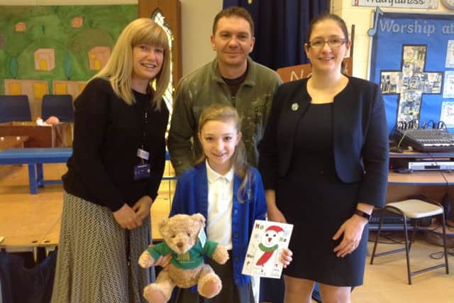 Maddie Keir with her Christmas card and bear, parents Julie and Marshall Keir and MP Dr Caroline Johnsno (right). EMN-171214-173039001