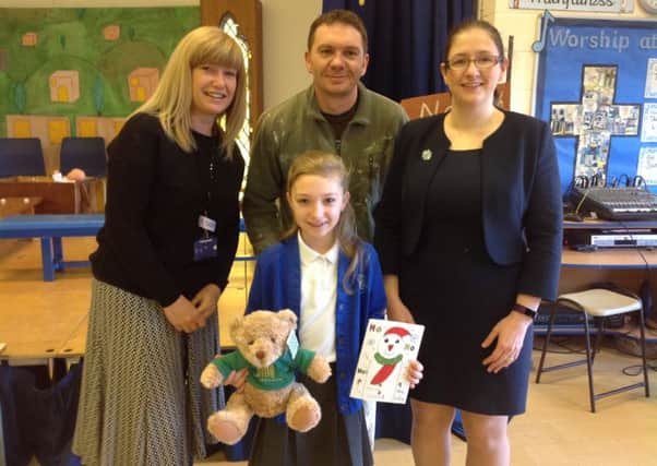 Maddie Keir with her Christmas card and bear, parents Julie and Marshall Keir and MP Dr Caroline Johnsno (right). EMN-171214-173039001