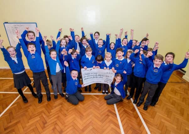 Children with the Â£5,000 cheque for Children In Need.