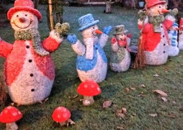 A parade of snowmen adorn the garden at Westwold Cottage. EMN-171213-161448001